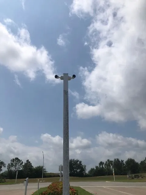 High-definition CCTV camera installed at the entrance to a Manatee County gated community, providing clear surveillance.